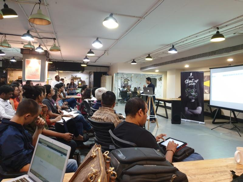 Nitin Raghani presenting at a startup workshop in a co-working space